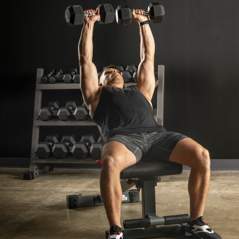 Man using FID bench for dumbbell chest press